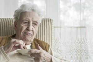 Elderly lady with Parkinson’s eating biscuit