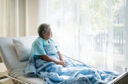 elderly woman in bed lonely