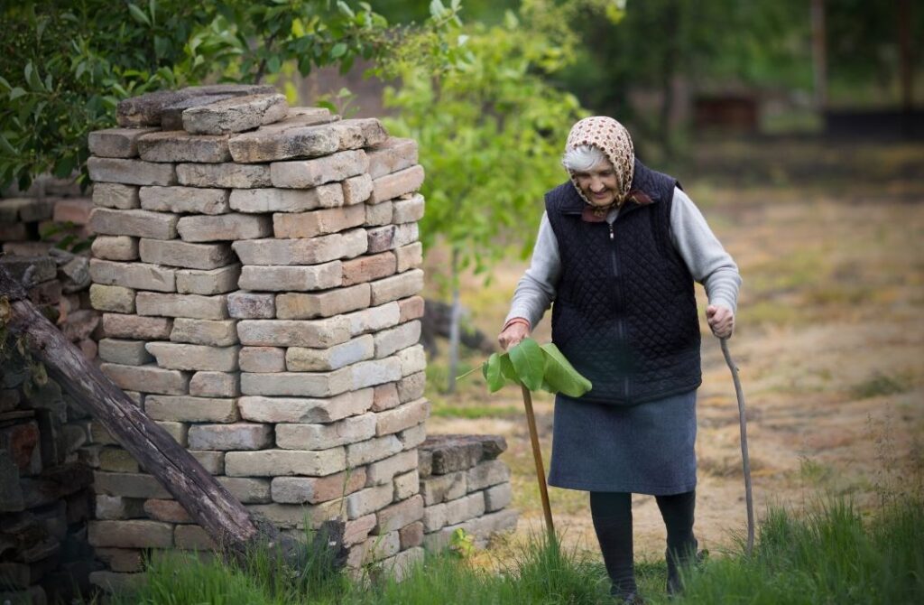 elderly woman with dementia walking in woodland