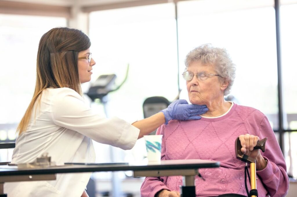 elderly woman having trouble swallowing fallowing a stroke