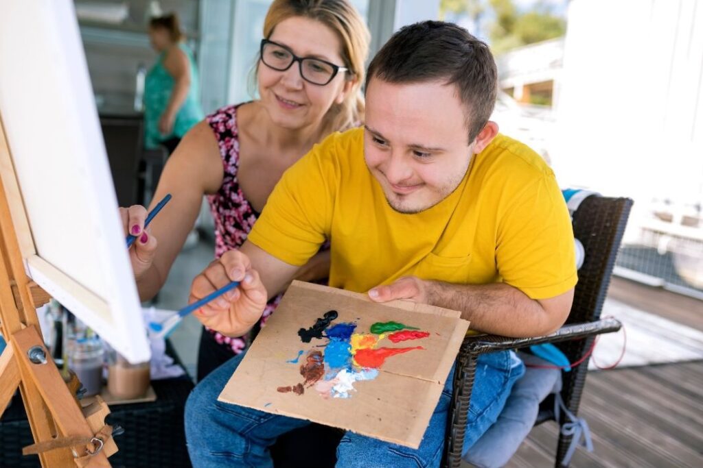 man with down syndrome painting