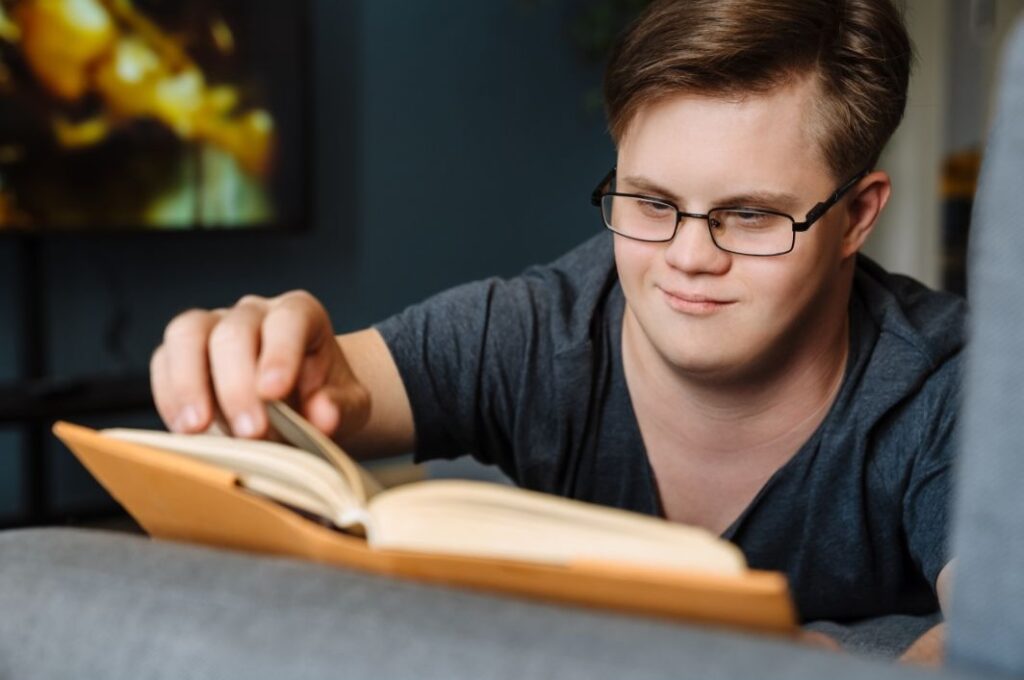 man with down syndrome reading