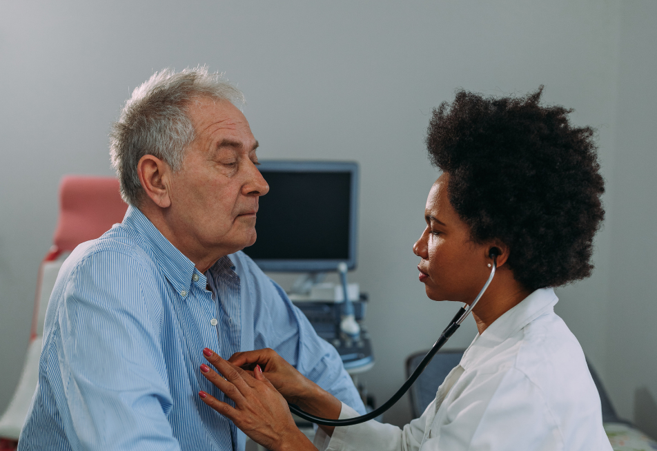 A doctor uses a stethoscope to examine a patient's chest during a medical check-up